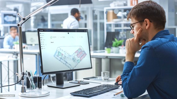 employee-at-desk-checking-blueprint.jpg (165 KB)